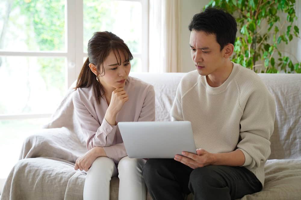 Asian couple reviewing divorce and mediation paperwork.